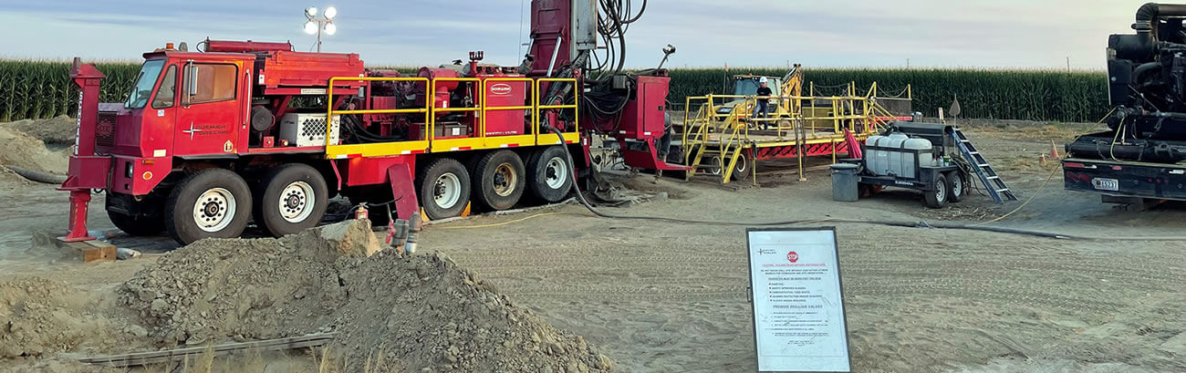 Safety Notice posted at irrigation well drilling site T130 rotary drill rig