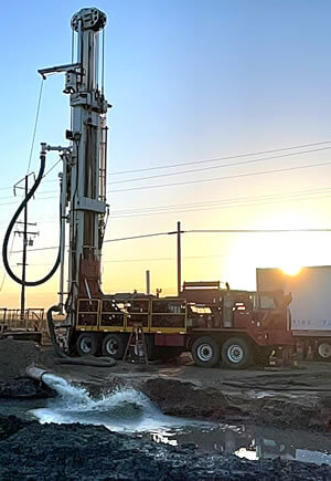 Water gushing from new irrigation water well T130 drill rig