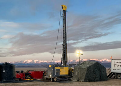 Lithium exploration drill site with a core drill rig and support equipment.