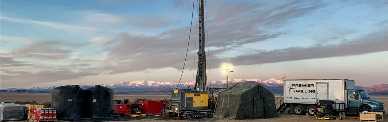 Rotary drill rig and Premier Drilling Co support equipment set up on a Nevada mineral exploration drill site